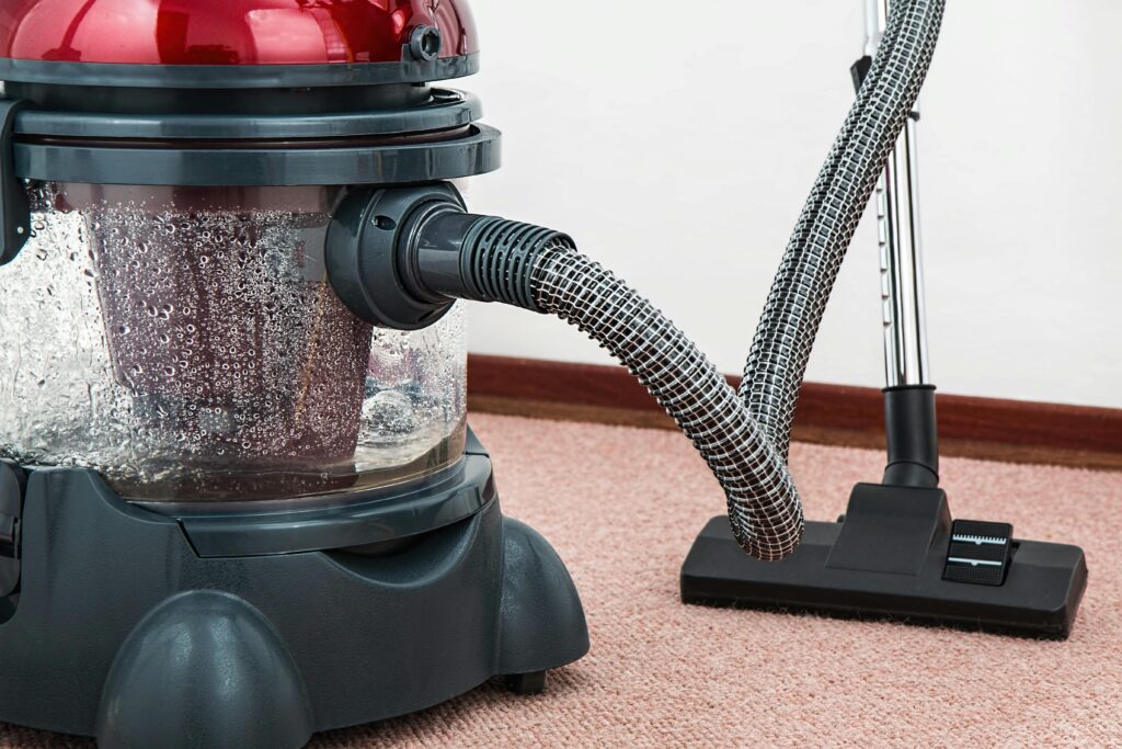 Water extraction vacuum removing moisture from carpet during water damage restoration.